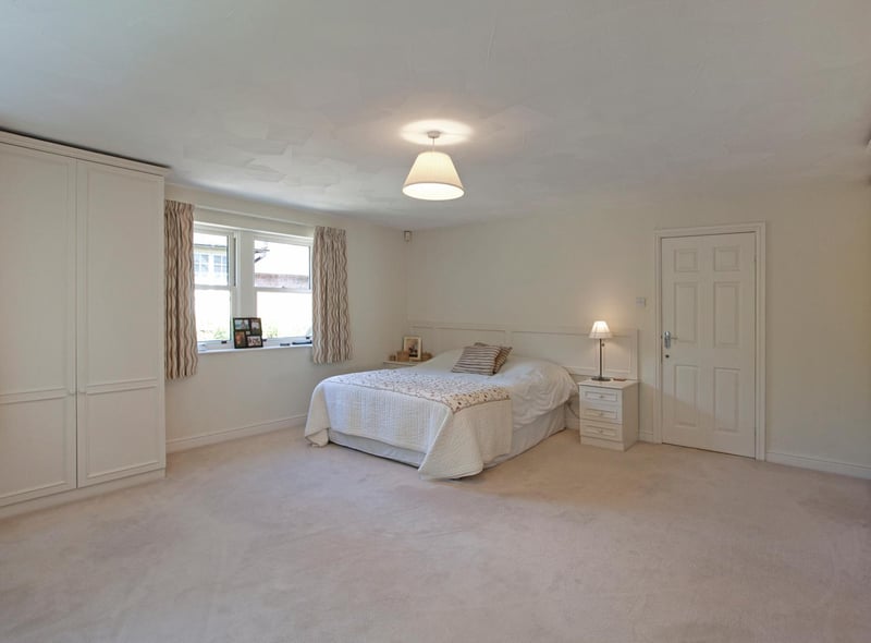 The principal bedroom with built in wardrobes and en-suite bathroom.