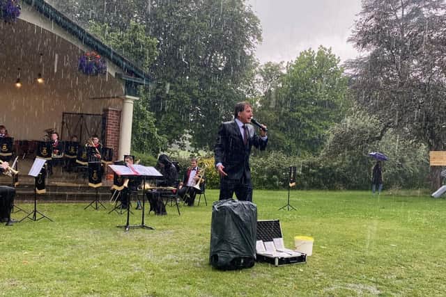 Rain of glory  - Musical Director Martin Hall and the Tewit Youth Band brave the storm to carry on playing in their first Harrogate concert in months.