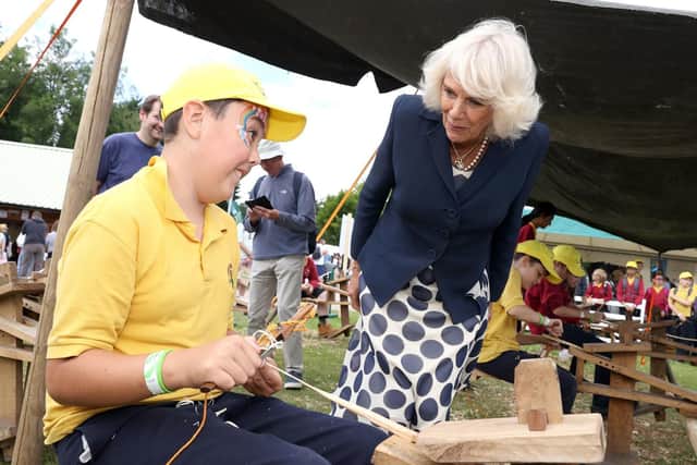 The Duchess of Cornwall speaks to a young boy making a wand at the children's education "Discovery Zone" during a visit to the Great Yorkshire Show. Image: Chris Jackson/PA Wire Writer: