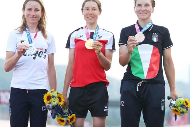 From left: Silver medalist Annemiek van Vleuten of Team Netherlands, gold medalist Anna Kiesenhofer of Team Austria, and bronze medalist Elisa Longo Borghini of Team Italy, pose on the podium.