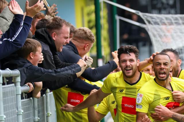 Warren Burrell and his Town team-mates celebrates with the fans behind the goal at the hospital end of the EnviroVent Stadium.