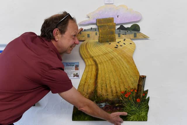 Andy Grinter of Art In The Mill with a piece of work by local artist Ray Mutimer. Part of the Feva Art Trail. Picture Gerard Binks