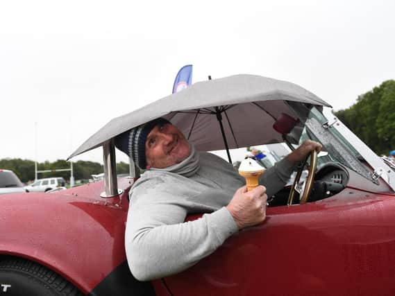 Jamie Hill enjoys an ice cream under the brolly in his AC Cobra