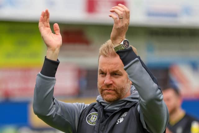 Simon Weaver applauds the travelling support.