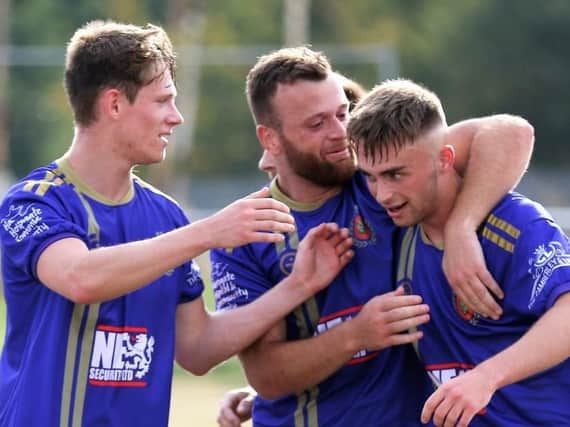 Jimmy Gore, right, is congratulated by Harrogate Railway team-mates Fatlum Ibrahimi, centre, and Josh Hardcastle after finding the net against Ollerton Town. Picture: Craig Dinsdale