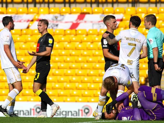 Harrogate Town winger Jack Diamond, second from left, leaves the field having been shown a second yellow card by referee Andrew Kitchen following a challenge on Port Vale goalkeeper Lucas Covolan. Pictures: Matt Kirkham