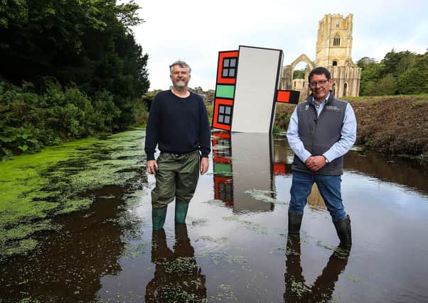 Artist Richard Woods, left, and Justin Scully, National Trust General manager of Fountains Abbey at the unveiling of an art installation titled Forever Home by Richard, commissioned by The Climate Coalition to mark Great Big Green Week, at Fountain Abbey, The National Trust property in Yorkshire. Picture: Nigel Roddis/PA Wire