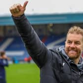 Simon Weaver acknowledges Harrogate Town's travelling support following Saturday's 2-1 win at Oldham Athletic. Pictures: Matt Kirkham