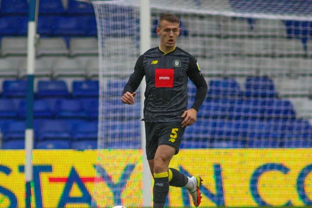 Will Smith in action on his return to Harrogate Town's starting line-up at Boundary Park.