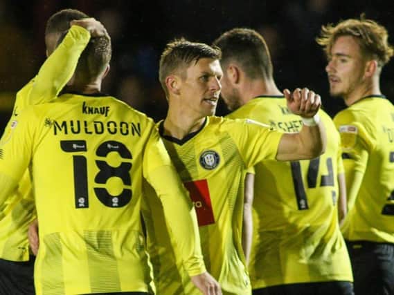 Harrogate Town celebrate after Lloyd Kerry, centre, fired them into an early lead against Newcastle United U21s. Pictures: Matt Kirkham