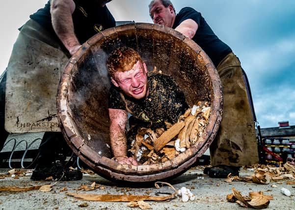 Euan Findlay in a barrel during the trussing in ceremony at Theakston Brewery.  Picture James Hardisty