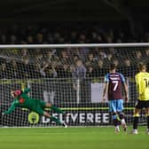 Harrogate Town goalkeeper Mark Oxley is beaten by Jay Spearing's 32nd-minute penalty. Pictures: Matt Kirkham