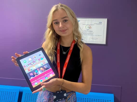 Harrogate Hospital and Community Charity Volunteer Mary McIntee with one of the tablets for dementia patients