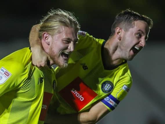 Luke Armstrong, left, is congratulated by Harrogate Town skipper Josh Falkingham after netting his eighth goal of the season during Tuesday's 2-2 draw with Tranmere Rovers. Picture: Matt Kirkham