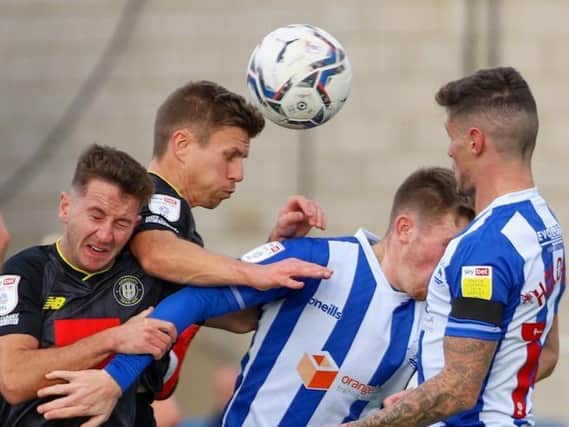 Josh Falkingham and Lloyd Kerry compete for possession during Harrogate Town's 3-2 defeat at Hartlepool United. Pictures: Matt Kirkham