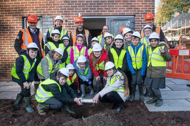 Children and teachers from Woodfield Community Primary School with Mark Smith, Managing Director at The HACS Group; Freddie Hebdon, Project Manager at Brierley Homes; Sam Ellis, Site Manager at The HACS Group and Andrew Brumfitt, Group and Safety Manager at The HACS Group