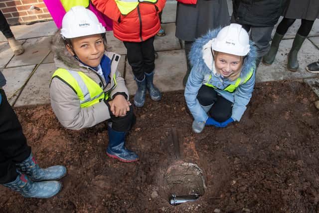Children from Woodfield Community Primary School at the burial of the time capsule