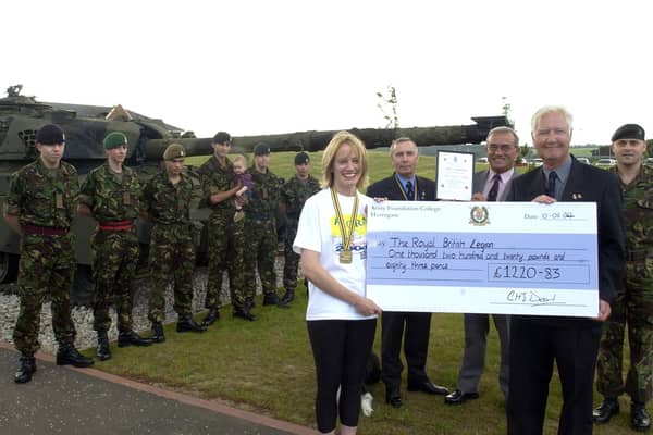 A marathon fundraiser for the RBL.  Left to right with the cheque are Claire Crabb, Royal British Legion Branch Chairman Gordon Townsley, Royal British Legion Field Officer Colin Northridge, Poppy Appeal Organiser David Marshall and Peninsula Company OC Lawrence Crabb.