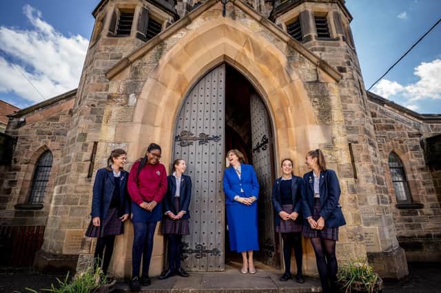Principal Mrs Sylvia Brett with some pupils in front of the school’s historic chapel