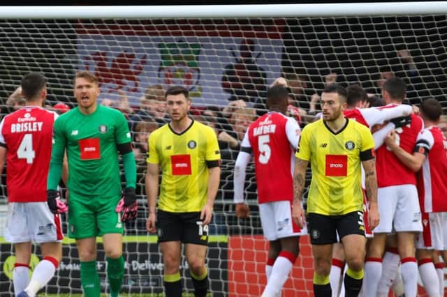 Harrogate Town players trudge away as Wrexham celebrate taking a 38th-minute lead during Saturday's FA Cup first round clash at Wetherby Road. Pictures: Matt Kirkham