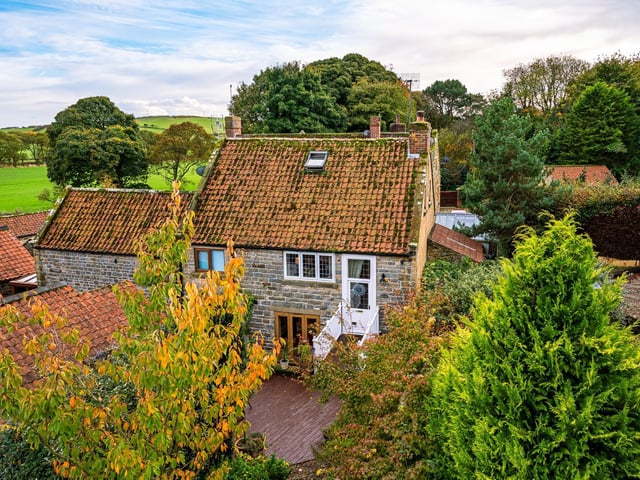 Looking down over the cottage in its leafy location.