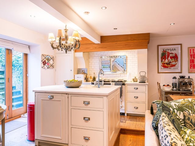 The bright kitchen has a stand alone island unit