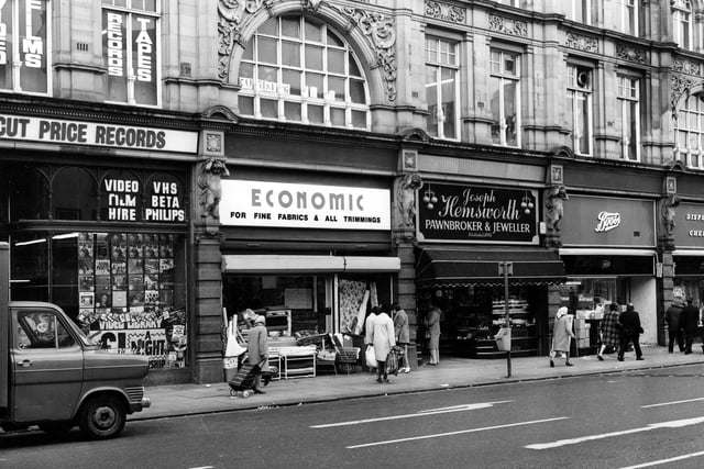 Kirkgate Market seen from Vicar Lane in May 1984. From left can be seen Cut Price Records, no.13 Market Buildings, then Economic Woollen Company, fabrics no.14, Joseph Hemsworth, jeweller, no.15 and Boots the chemist at no.16.