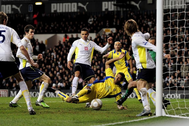 Jermaine Beckford of Leeds forces the ball past the Tottenham defence to level the scores.