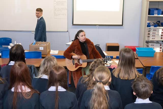 Members of Wensleydale School Choir with Bethzienna William at their song writing workshop