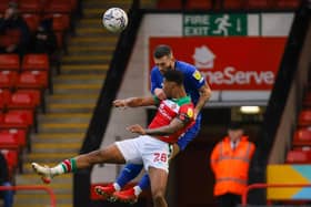 Harrogate Town left-back Lewis Page climbs above Walsall's Tyrese Shade to head the ball clear. Pictures: Matt Kirkham