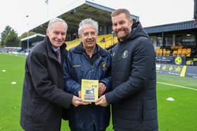 Book launch - Harrogate Town photographer Matt Kirkham's picture of Harrogate Town historian Phil Harrison, centre, with the club's chairman Irving Weaver and manager Simon Weaver at the EnviroVent Stadium.