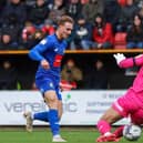 Jack Diamond beats Jojo Wollacott to fire Harrogate Town into a first-half lead at Swindon Town. Picture: Matt Kirkham