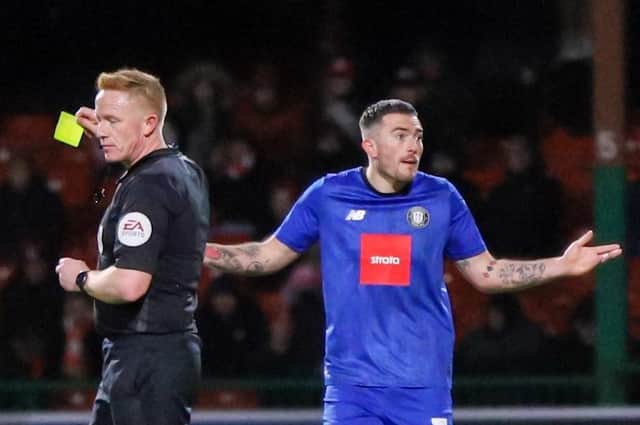 Harrogate Town left-back Lewis Page cannot hide his belief after being booked by referee Alan Young during the second half of Saturday's 1-1 League Two draw at Swindon Town. Pictures: Matt Kirkham