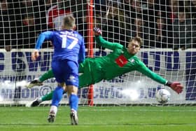 Harrogate Town goalkeeper Mark Oxley is beaten by Jack Payne's late penalty during Saturday's League Two draw at Swindon Town. Picture: Matt Kirkham