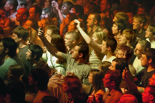 The caption with this reads 'Fans take pictures on their mobile phones at the Richard Ashcroft concert at the Empress Ballroom' It was a big deal back in 2006 as the age of mobiles took hold