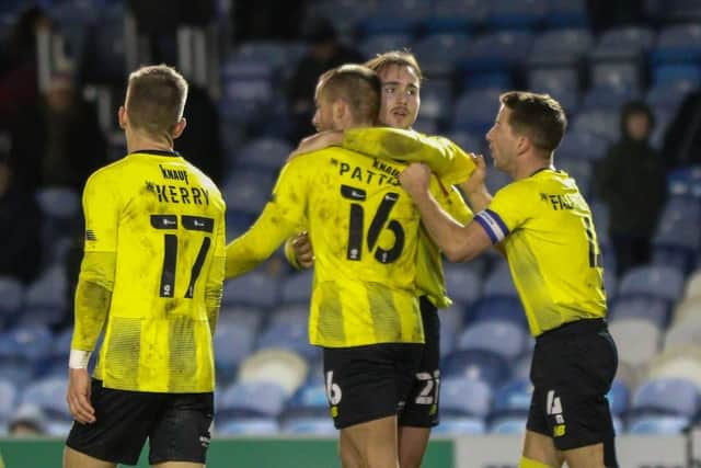 Jack Diamond takes the congratulations of his Harrogate Town team-mates.