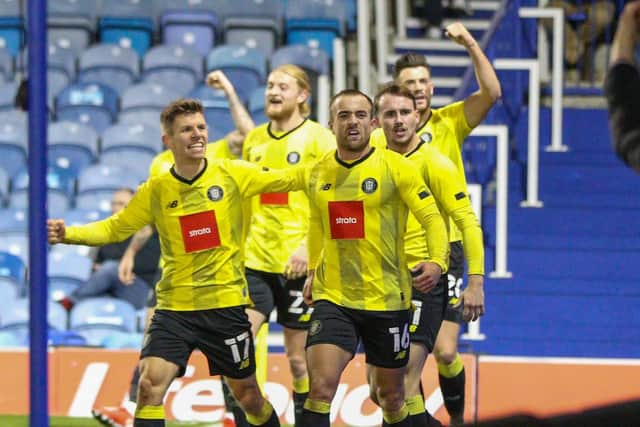 Harrogate Town players celebrate taking a last-gasp 2-1 lead in front of their travelling support. Picture: Matt Kirkham