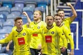 Harrogate Town players celebrate their last-gasp winner at Portsmouth. Pictures: Matt Kirkham
