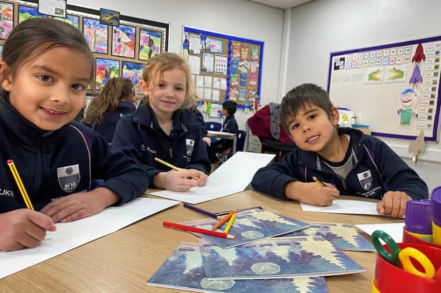 Year one pupils Maryam, Isabelle and Rubin writing their Christmas Cards to be sent to alumni of The Grammar School at Leeds