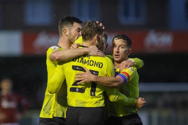 Jack Diamond is congratulated by his Harrogate Town team-mates after netting a 24th-minute equaliser against Northampton Town.