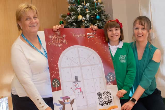 Helen Suckling, Partnership and Commercial Manager at Visit Harrogate, student Molly Hall and Mrs Acheson, Headteacher at Grewelthorpe C of E Primary School, celebrate Molly’s winning window design which is now on display at Ripon Library