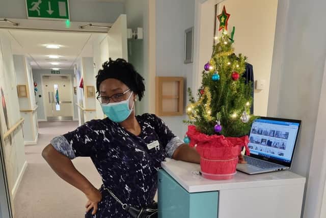 Nurse Glades with her gifted miniature Christmas tree from Holly Berry Trees