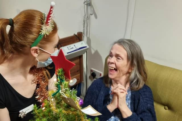 Barbara and Lauren admiring their gifted miniature Christmas tree from Holly Berry Trees