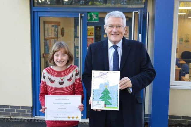 Harrogate and Knaresborough MP Andrew Jones with winning card designer, Martha Allsopp, a pupil at Richard Taylor School in Harrogate.