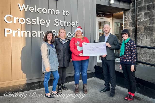 Crossley Street Primary receive a cheque for £9,192 from the school’s PTA, to help buy IT equipment. Pictures: Kirsty Bowe Photography.