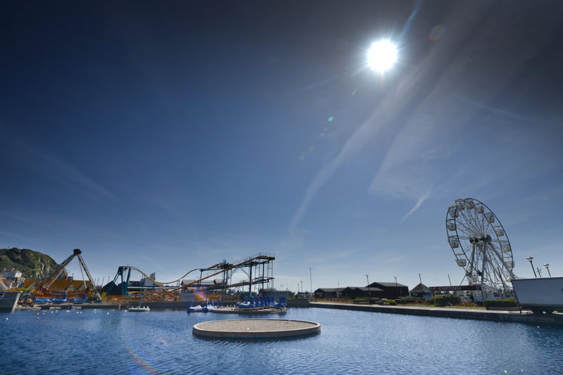 Boating lake (Swan Lake Pedal Boats) on East Parade, Hastings.
The Pinball X spinning roller coaster is pictured in the background along with Hastings' big wheel. SUS-210422-123606001