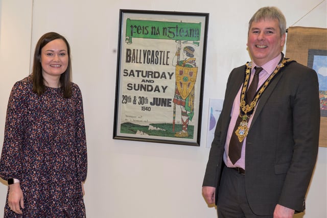 Museum Services Assistant Rachel Archibald and the Mayor of Causeway Coast and Glens Borough Council Councillor Richard Holmes with a poster from Feis na nGleann dating back to 1940 which is on display in the new ‘100 Objects for 100 Years’ exhibition in Ballymoney Museum