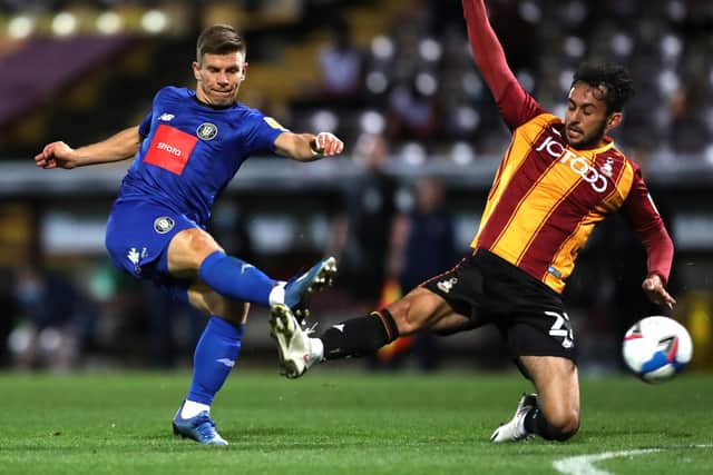 Harrogate Town's Lloyd Kerry and Levi Sutton of Bradford City go head-to-head at Valley Parade back in 2020. The former Sulphurites midfielder is now Town's head of recruitment and was instrumental in brokering the deal which saw Sutton move to Wetherby Road. Picture: George Wood/Getty Images
