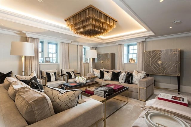 The spacious and modern sitting room is separated from the study by a feature fireplace.