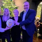 HRH Group MD Simon Cotton, Emily Roberts and Ashleigh Lambert of Cenheard and David Croft of Black Sheep with the signed Leeds United football.